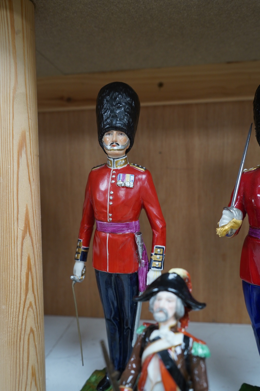 A pair of Sevres style Napoleonic figures and three others including Worcester, tallest 30cm. Condition - fair to good